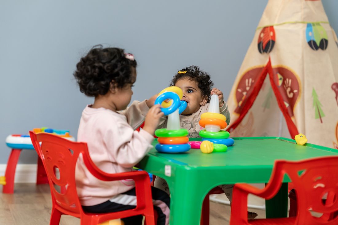 Toddlers playing with stacking rings
