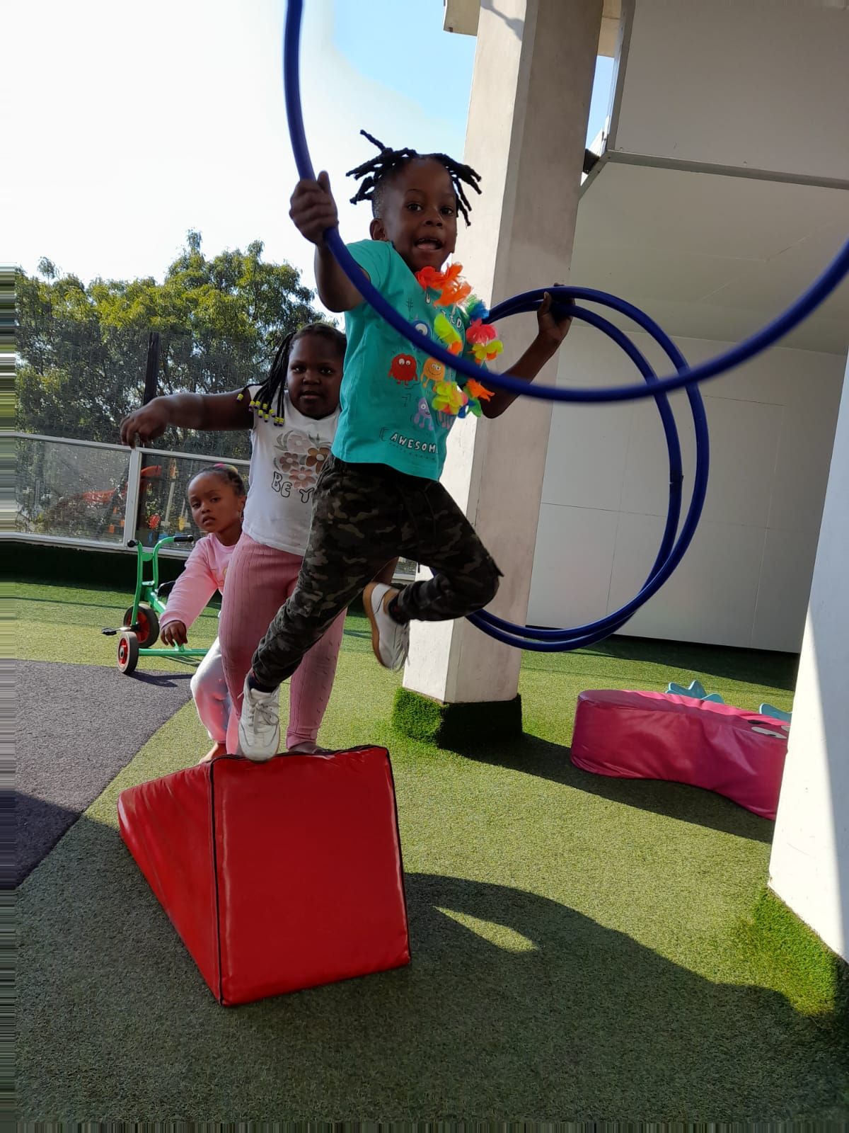 Child swinging through hoops on the obstacle course